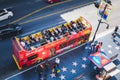 A double-decker Starline sightseeing bus beside pedestrians walk along the Hollywood Walk of Fame, in an overhead view