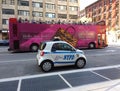 Double Decker Tour Bus Drives Past a Mini NYPD Vehicle, New York City