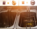 Double deep fryer for cooking french fries, on rustic and slices of potatoes, kitchen, close-up