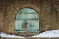 Double doors covered with ivy. vintage blue garden gate door in a green hedge row. rustic wooden door of an underground old- Royalty Free Stock Photo