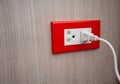 Double electrical power socket and single plug switched on wood Royalty Free Stock Photo