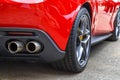 Double exhaust pipes of a modern red sports car. Royalty Free Stock Photo