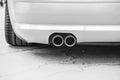 Double exhaust pipes of a modern sports car, black and white Royalty Free Stock Photo