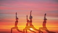 Double exposue background of group of caucasian people having yoga workout outdoors with overlay background of sunset sky