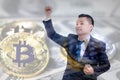 Double exposure of asian businessman celebrating Successful with golden bitcoin on dollar banknotes background, Royalty Free Stock Photo