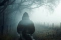 A double exposure of an atmospheric half transparent man looking at a foggy path in the countryside. On a moody foggy winters day