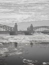 Double exposure of the bridge over the river against the background of the ice drift. Royalty Free Stock Photo