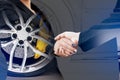 Double exposure of business handshake with wheel car