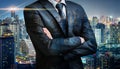 Double exposure of business man folded arms on city night background Royalty Free Stock Photo