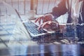 Double exposure of business man working online on laptop computer, close up of hands