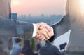 Double exposure of Business people handshake wearing suits on building