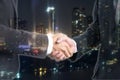 Double exposure Business people shaking hands with view night ti Royalty Free Stock Photo