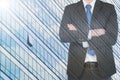 Double exposure of businessman with cityscape building glass