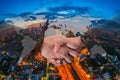Double Exposure of a businessman handshake on World Global Cartography Globalization with Aerial view of cityscape at twilight, B