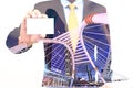 Double exposure of Businessman holding or showing blank business card and city background Royalty Free Stock Photo