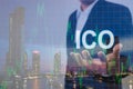 Double exposure of businessman holding text ico on hand and defocused chart background with modern city background Royalty Free Stock Photo