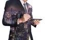 Double exposure of businessman working with tablet, night city