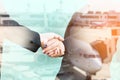 Double exposure of businesspeople handshake with aeroplane