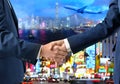 Double exposure of Businesspeople shaking hands with airplane flying, city and urban in the night as commitment Royalty Free Stock Photo