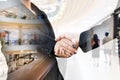 Double exposure of businesspeople shaking hands with shopping mall