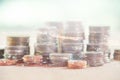 Double exposure of city and rows of coins