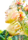 Double exposure close up profile portrait of a young pretty woman interwoven with delicate red and yellow flowers seemingly Royalty Free Stock Photo