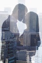 Double exposure of couple kissing over cityscape, side view, silhouette