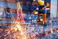 Double Exposure of Craftsman Welding is Cutting Steel Frame on City Background, Welder Man in Safety Protective Equipment Doing Royalty Free Stock Photo