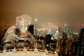 Double exposure Giant Buddha sitting on lotus in Hong Kong,Night view of the peak city life.