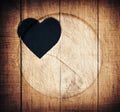 Double exposure of heart shape and wooden circle