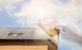 Double exposure of house with solar panels and woman using calculator. Renewable energy and money saving Royalty Free Stock Photo