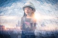 The double exposure image of the engineer girl standing during sunrise overlay with cityscape image and futuristic hologram. The c