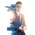 The double exposure image of the smart businessman standing during sunrise overlay with cityscape image.