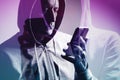 Double exposure of man in hoodie using smartphone, creative concept symbolizing technology, connection, and digital identity Royalty Free Stock Photo
