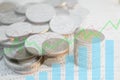 Double exposure of money coins stack with growing graph. Royalty Free Stock Photo