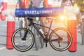 Double exposure mountain bicycle and inflatable start - finish arch with cyclists during bicycle sport racing competition