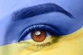 Double exposure of national flag and young woman, closeup of eye. Stop war in Ukraine Royalty Free Stock Photo