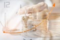 double exposure of old person hold house key ,analog clock and stack of coins with growing graph ,business background Royalty Free Stock Photo