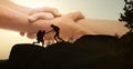 Double exposure of people climbing up mountain and helping hand Royalty Free Stock Photo