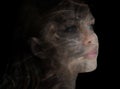 Double exposure portrait of an attractive woman combined with a photograph of a smoke