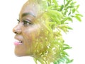 A portrait of an African American woman combined with an image of green leaves in a double exposure technique. Royalty Free Stock Photo