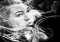 Double exposure portrait of woman and smoke. Royalty Free Stock Photo