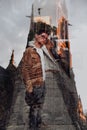 Double exposure portrait of young woman combined with photograph of mountainious landscape shot from a plane