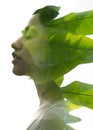 A double exposure portrait young woman profile with her eyes closed against white background and tropical foliage Royalty Free Stock Photo