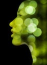 A double exposure portrait of a young woman's profile against black background Royalty Free Stock Photo