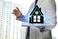 Double exposure of real estate agent with house illustration over tablet, apartment building