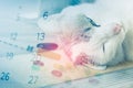 Double exposure of sick cat and medicine ,syringe with calendar