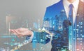 Double exposure of success business man city background.Hand hold something. Royalty Free Stock Photo