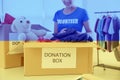 Double exposure of volunteer packing donation boxes and Ukrainian flag, closeup. Help during war