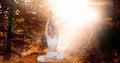 Double exposure of woman with hands clasped doing yoga in forest Royalty Free Stock Photo